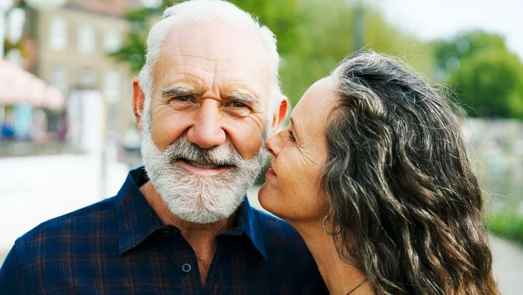 Senior couple sharing a warm moment outdoors